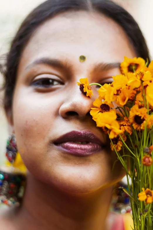 a woman holding a bunch of flowers in front of her face, an album cover, by Ingrida Kadaka, unsplash, bangladesh, lesbians, icon, full close-up portrait