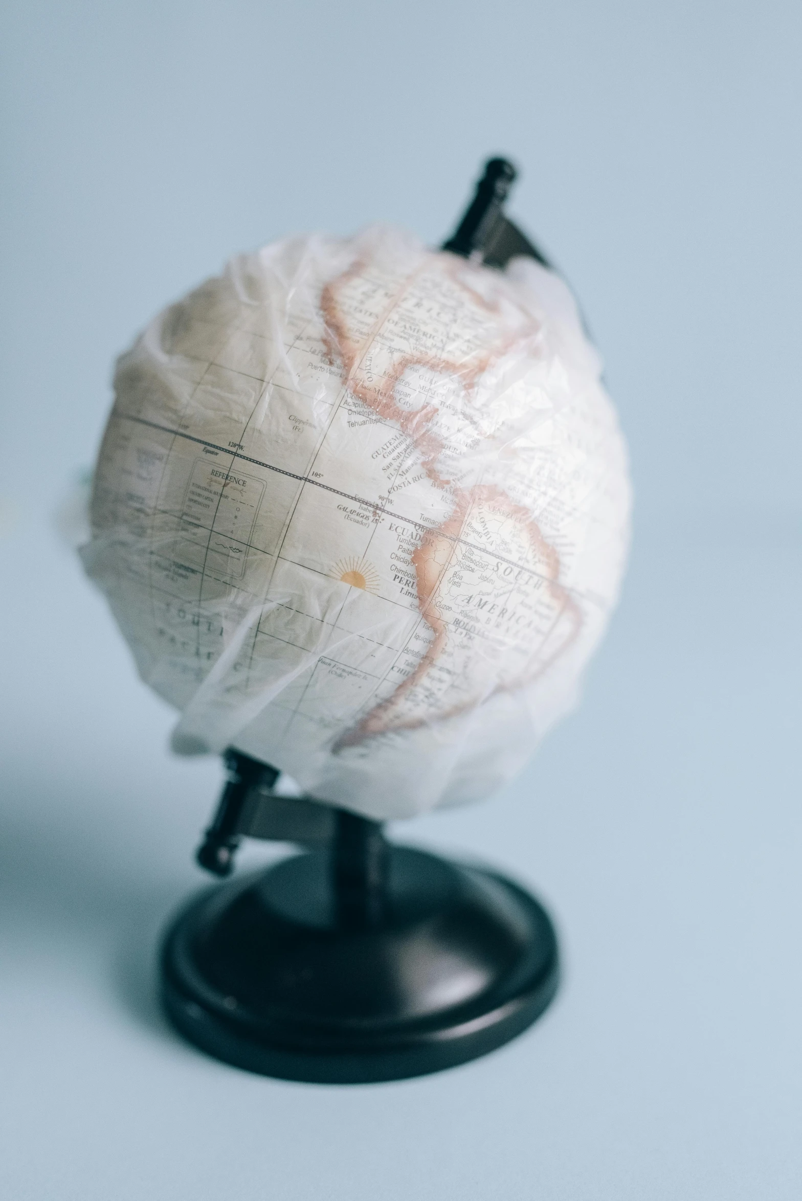 a white globe sitting on top of a black stand, made of lab tissue, full of details, jen atkin, closeup