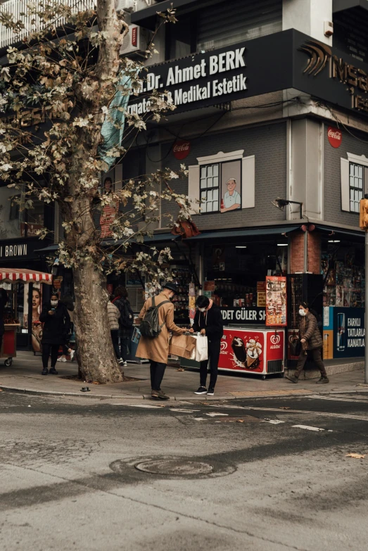 a group of people walking down a street next to a tall building, bookshops, istanbul, top selection on unsplash, thumbnail