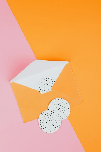 an open envelope sitting on top of an orange and pink background, by Julia Pishtar, greeting card, half image, die - cut sticker, polka dot