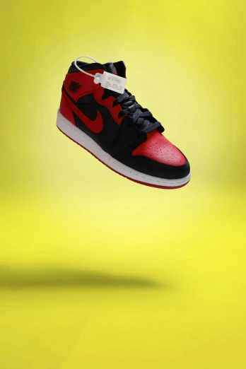 a pair of red and black shoes floating in the air, an album cover, inspired by Jordan Grimmer, unsplash, hyperrealism, yellow infrared, “air jordan 1, snapchat photo, mini model