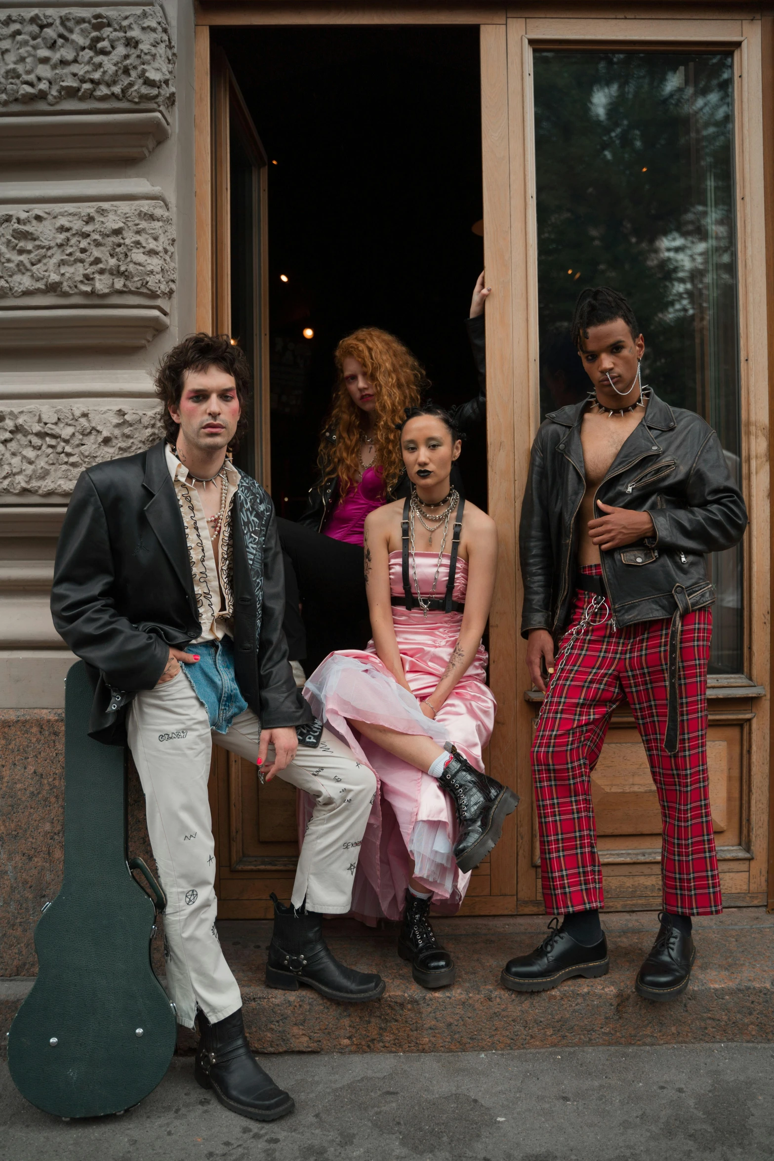 a group of people sitting on the steps of a building, an album cover, trending on pexels, renaissance, wearing a punk outfit, in new york, at a fashion shoot, doja cat