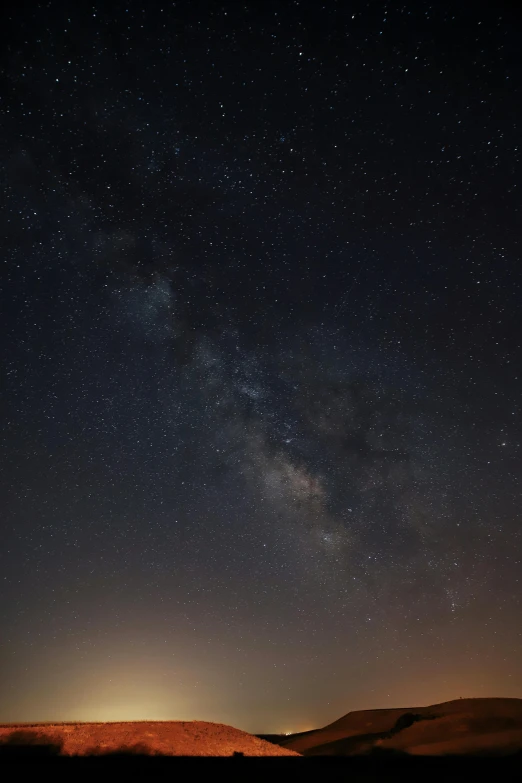 the milky shines brightly in the night sky, by Adam Pijnacker, pexels, dust atmosphere, ultra wide horizon, paul barson, sweet night ambient