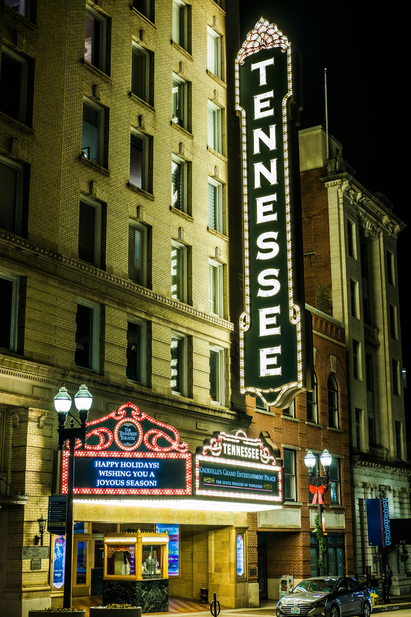 a theater marquee lit up at night, by Dan Frazier, renaissance, surrounding the city, profile image, tn, temples