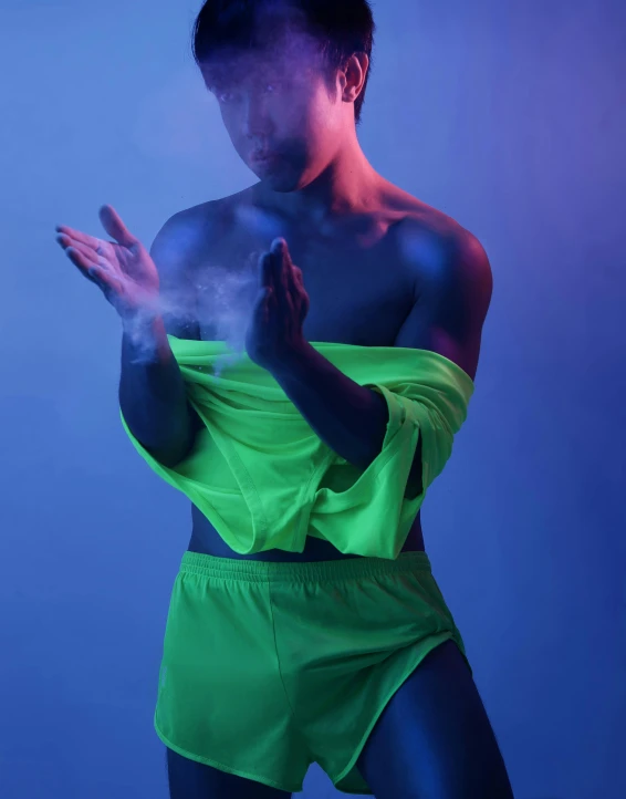 a woman in neon green posing for a picture, inspired by Russell Dongjun Lu, dust clouds | homoerotic, his arms spread, nonbinary model, brand colours are green and blue