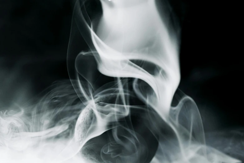 a close up of smoke on a black background, a black and white photo, unsplash, art photography, incense, floating ghost, spiraling, smoking rock