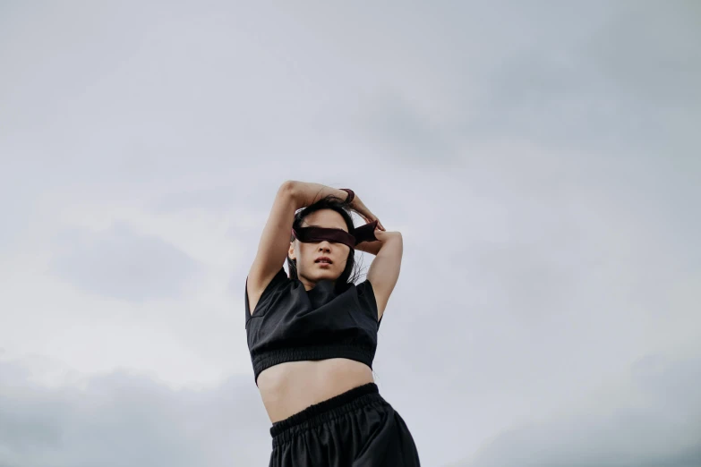 a woman in a black top and black shorts, trending on pexels, goggles on forehead, on a cloudy day, wearing a crop top, asian women