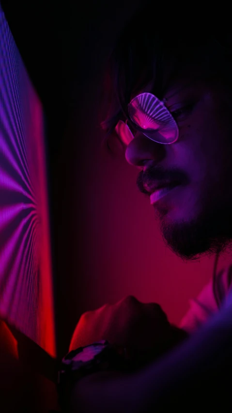 a close up of a person using a cell phone, by Max Dauthendey, pexels contest winner, process art, mirror shades, fuschia leds, afro tech, side lighting