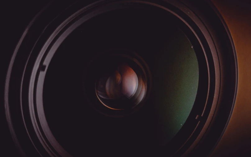 a close up view of a camera lens, unsplash, art photography, movie still 8 k, a round minimalist behind, looking in front, low-light photograph