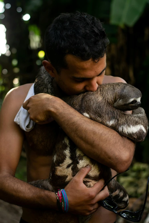 a man holding a baby sloth in his arms, tamandua, profile image