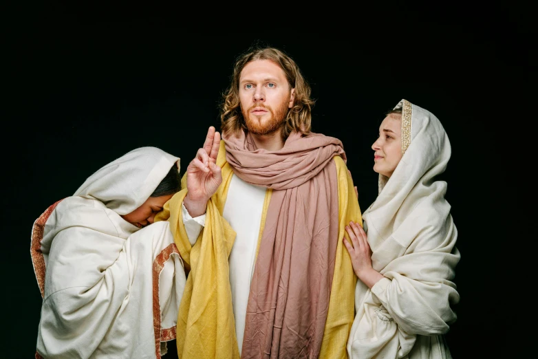 a group of people standing next to each other, by Matthias Stom, unsplash, renaissance, dressed like jesus christ, ( ( theatrical ) ), lachlan bailey, easter