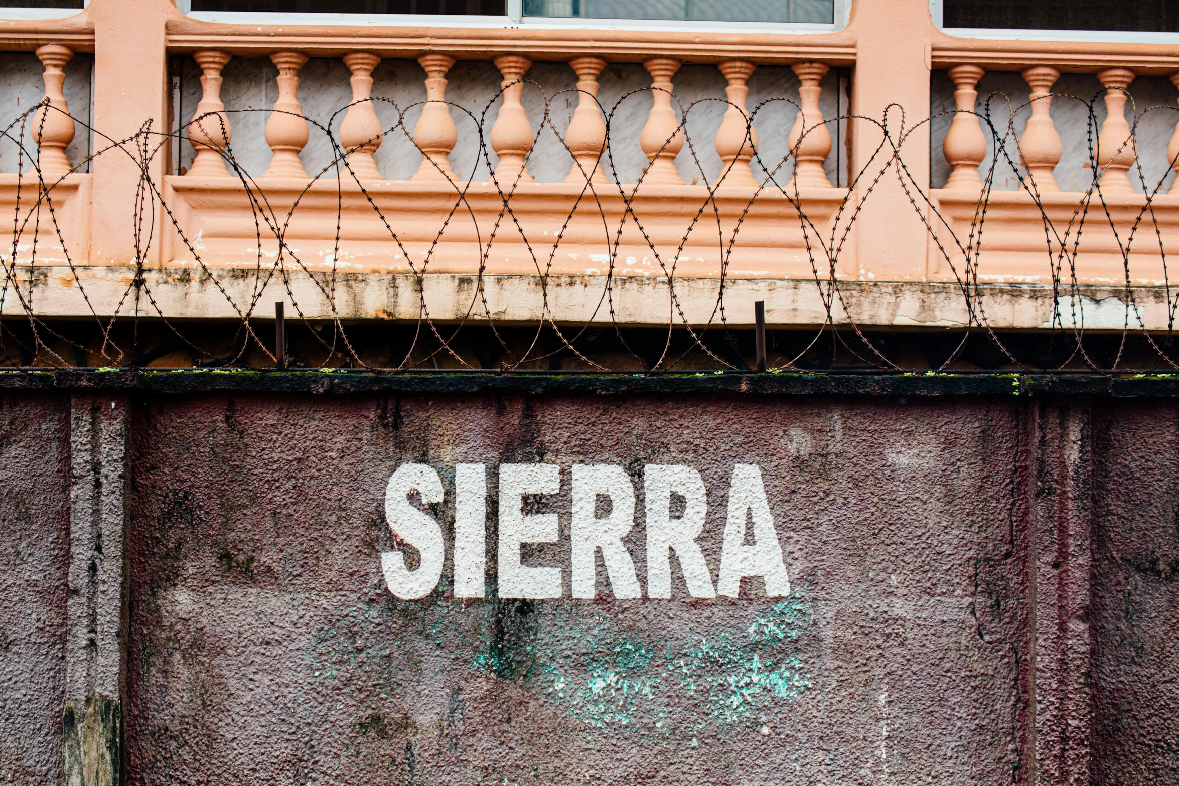 a sign that is on the side of a building, an album cover, inspired by William Berra, shutterstock, graffiti, arma 3, sierra games, 1999 photograph, silver nitrate photography