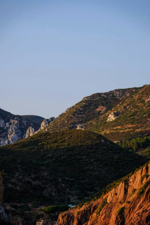 a lighthouse sitting on top of a cliff next to a body of water, hollister ranch, last light on mountain top, traditional corsican, seen from a distance