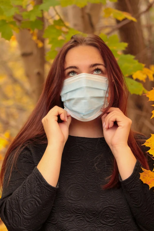 a woman wearing a face mask in the woods, a picture, fall foliage, promo image, high school, blank