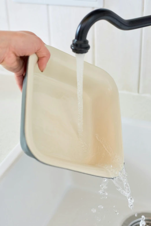 a person pouring water from a faucet into a sink, by Alison Watt, silicone cover, square, thumbnail, creamy