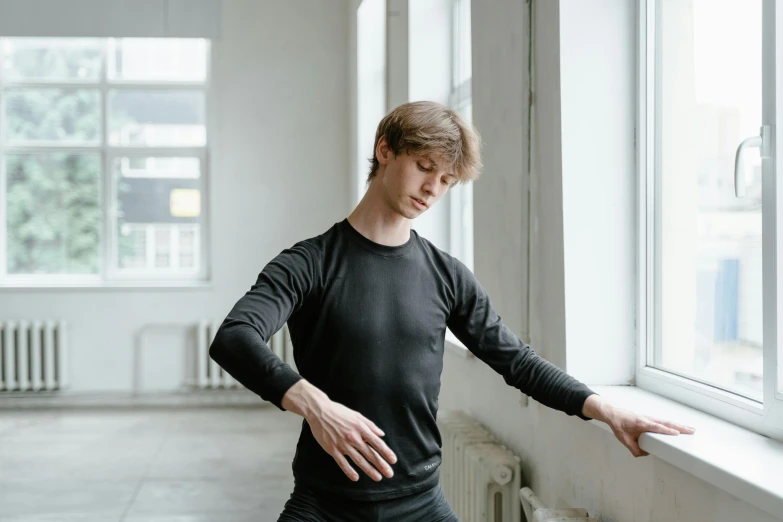 a man in a black shirt leaning against a window, inspired by Illarion Pryanishnikov, dance meditation, wearing leotard, smooth pale skin, gif