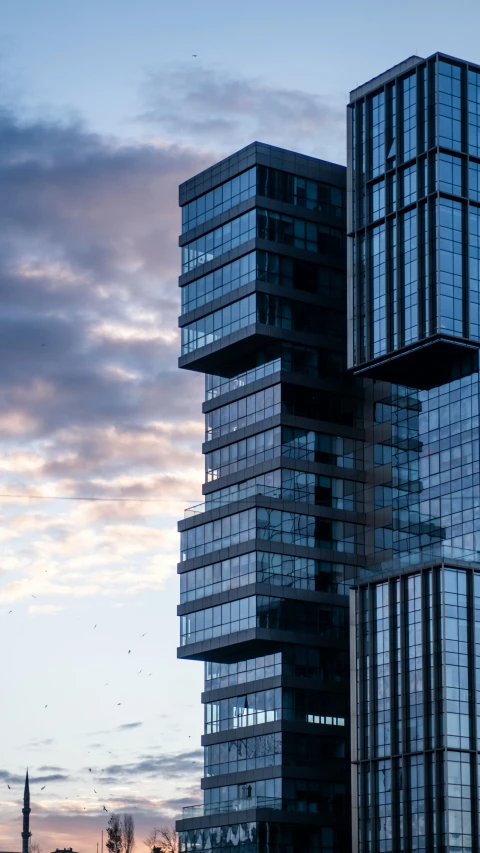 a couple of tall buildings sitting next to each other, by Matija Jama, unsplash contest winner, modernism, 4k detail post processing, bjarke ingels, tall obsidian architecture, in the early morning