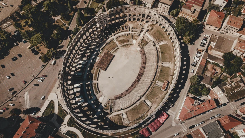 an aerial view of a large arena in a city, an album cover, pexels contest winner, renaissance, roman coliseum, epic theater, profile image, aerial view cinestill 800t 18mm