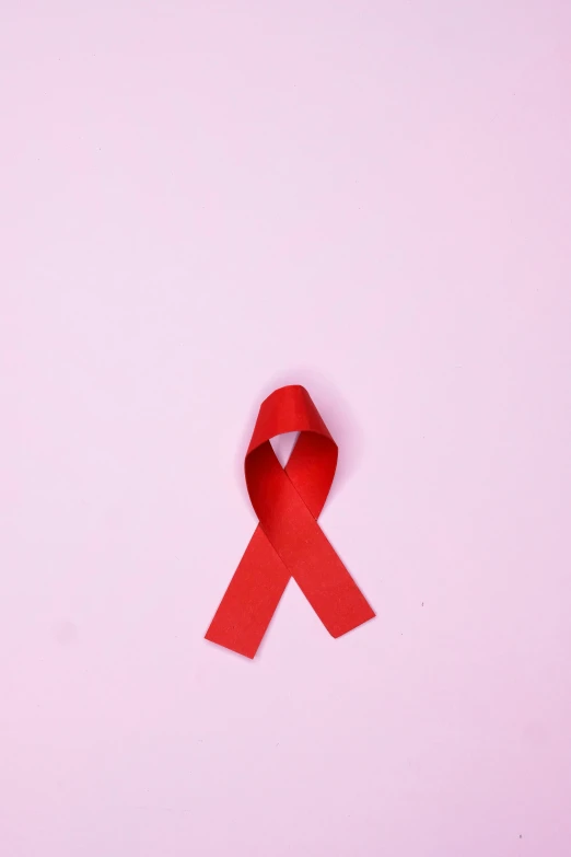 a red ribbon on a pink background, by Carey Morris, pexels, antipodeans, instagram picture, medical, on a gray background, drag