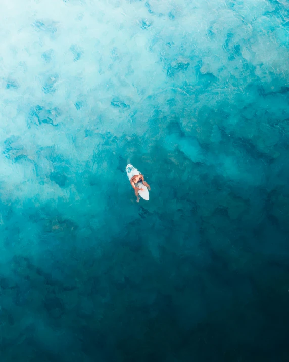 a person on a surfboard in the middle of a large body of water, pexels contest winner, lit from above, thumbnail, small boat, alana fletcher