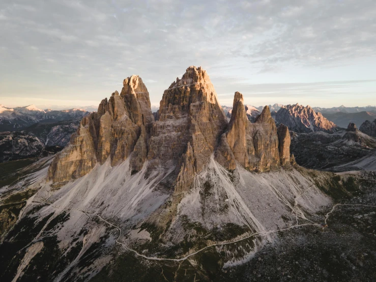 a group of mountains with snow on them, by Carlo Martini, pexels contest winner, renaissance, tall stone spires, drone photograpghy, late summer evening, wide angle”