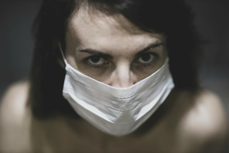 a close up of a person wearing a face mask, an album cover, pexels contest winner, nurse, aggressive look, suspense, virus