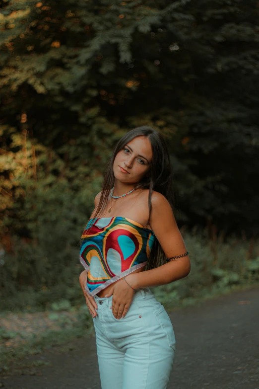 a woman standing in the middle of a road, an album cover, inspired by Elsa Bleda, trending on pexels, graffiti, wearing a low cut tanktop, multi colored, ukrainian girl, 🤤 girl portrait