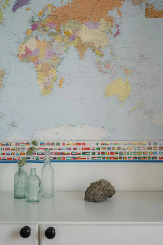 a map of the world on a wall above a dresser, by Jessie Algie, fine art, detiled, flags, detail shot, antarctica