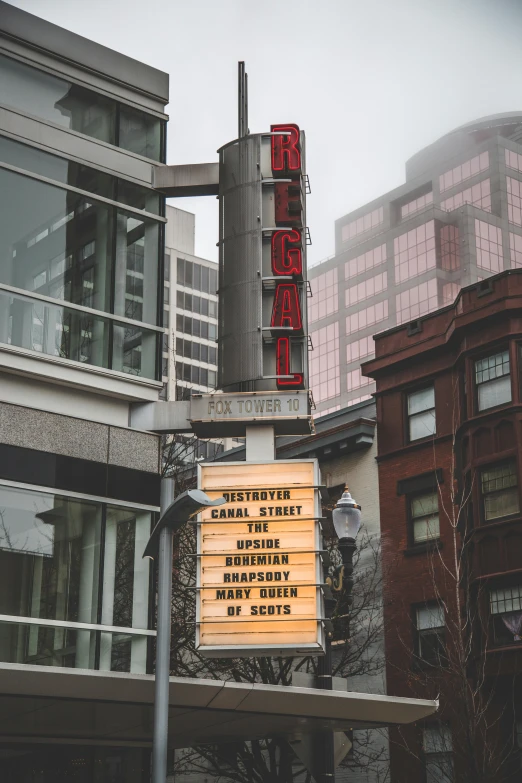 a sign on a pole in front of a building, by Dan Frazier, unsplash contest winner, serial art, epic theater, city mist softlight, regal, downtown