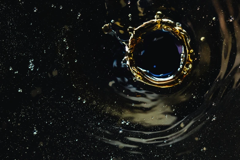 a close up of a sink with water coming out of it, an album cover, inspired by Otto Piene, unsplash, space art, blue black gold, floating crown, looking out into space, the ring