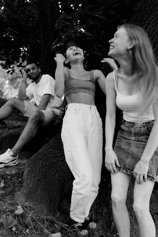 a black and white photo of a group of people, pexels contest winner, happening, wearing a camisole and shorts, tumblr aesthetic, both laughing, parks