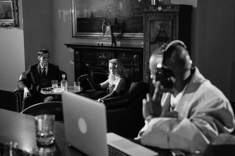 a group of people sitting around a table with laptops, inspired by Larry Fink, fine art, classic film noir scene, 📷 mungojerrie and rumpleteazer, a portrait of @hypnos_onc, making of