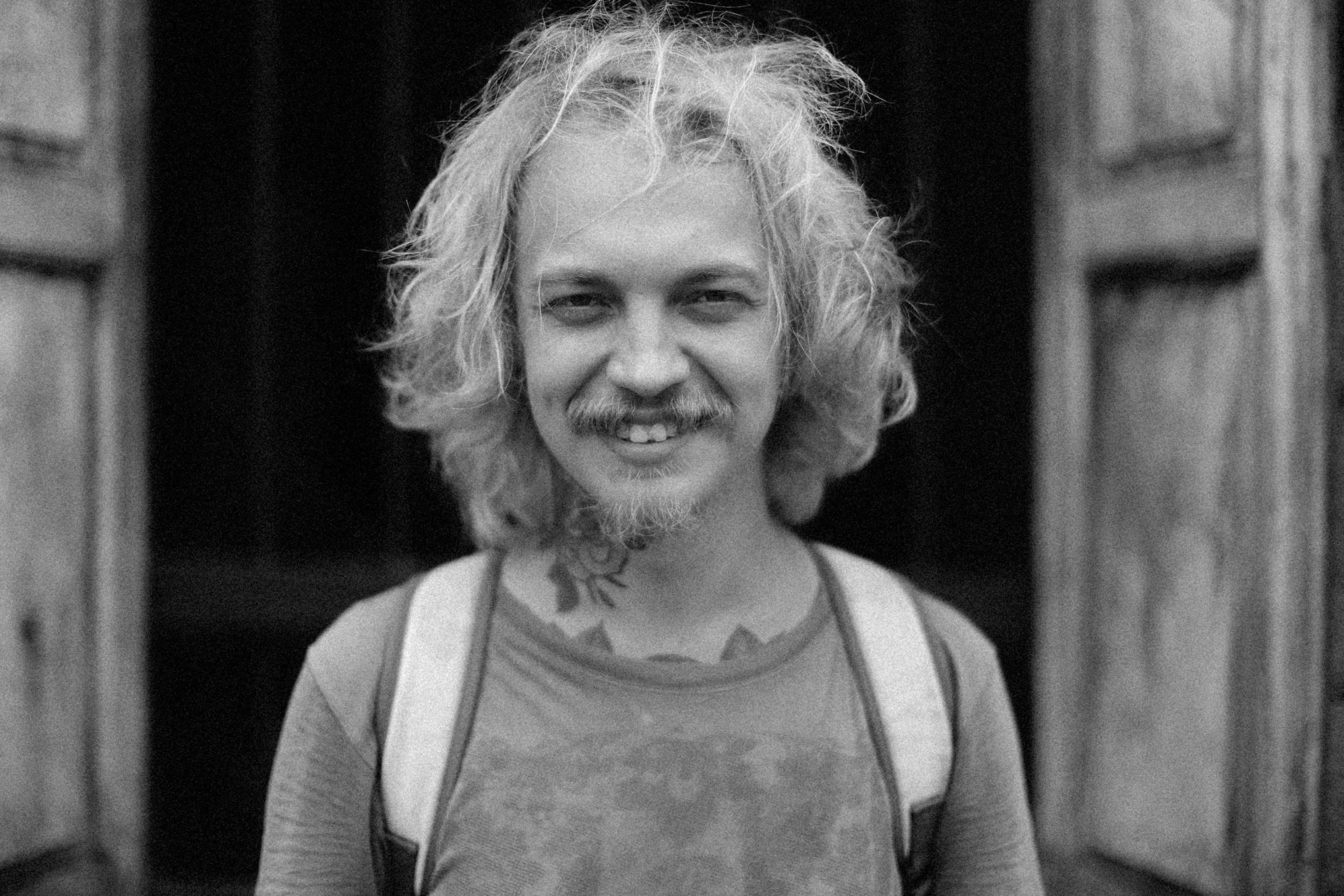 a black and white photo of a man smiling, reddit, renaissance, albino hair, keith harring, small blond goatee, by jim bush and ed repka