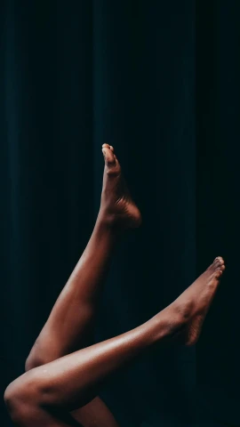 a close up of a person laying on a bed, by Nina Hamnett, trending on unsplash, arabesque, dance, low quality photo, black in, on a stage