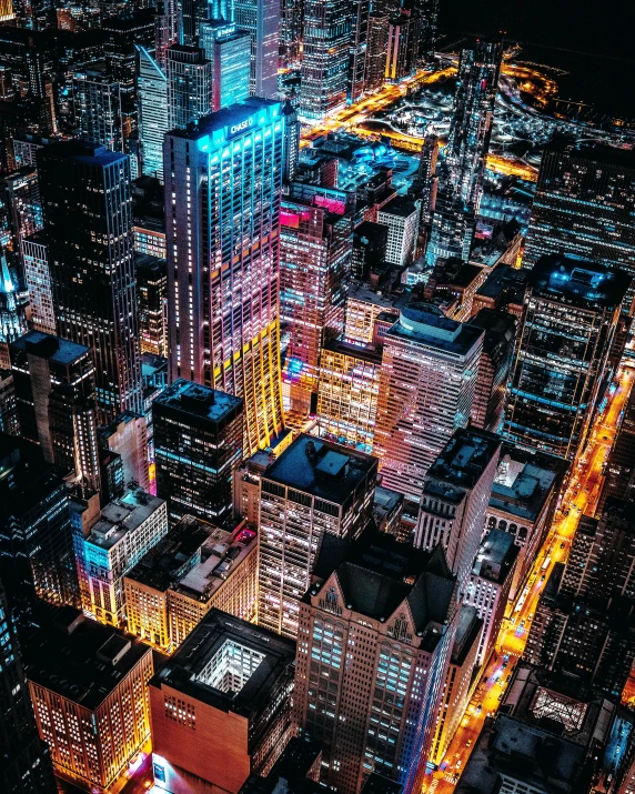 an aerial view of a city at night, pexels contest winner, pixel art, modern chicago streets, colorful building, gif, tall building