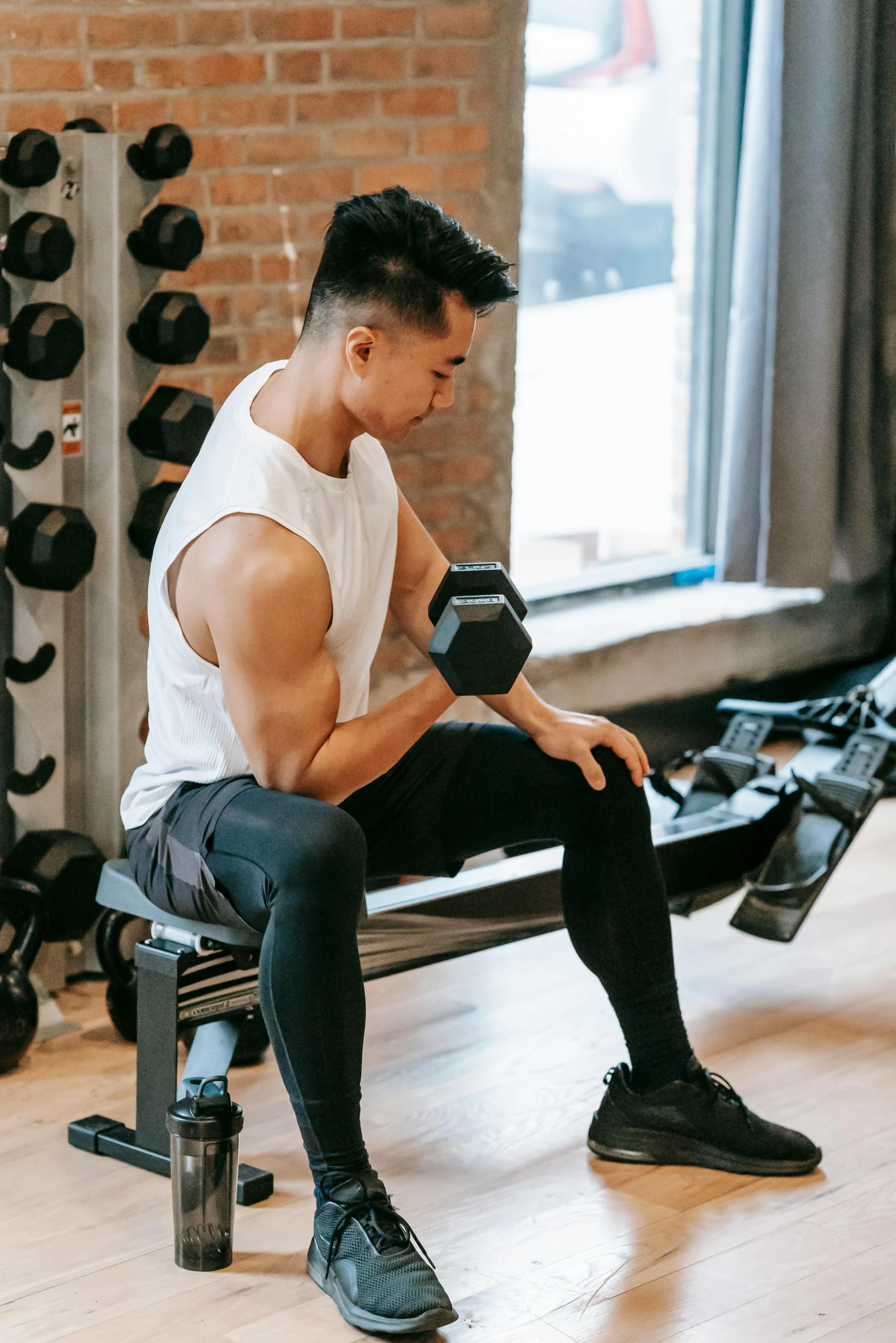 a man sitting on a bench in a gym, pexels contest winner, lean man with light tan skin, lifting weights, darren quach, 🦑 design