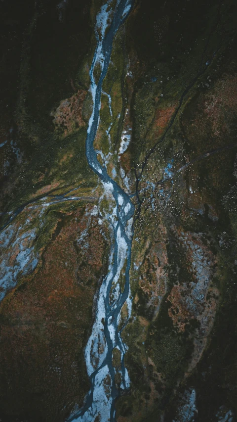 a river running through a lush green forest, an album cover, by Jacob Toorenvliet, unsplash contest winner, hurufiyya, snowy canyon at dawn, top down view, icy, lava river