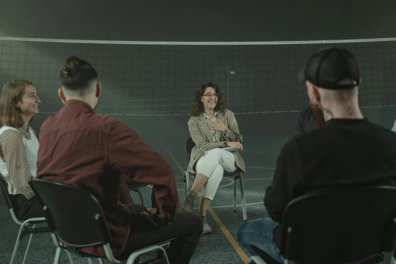 a group of people sitting in chairs in a room