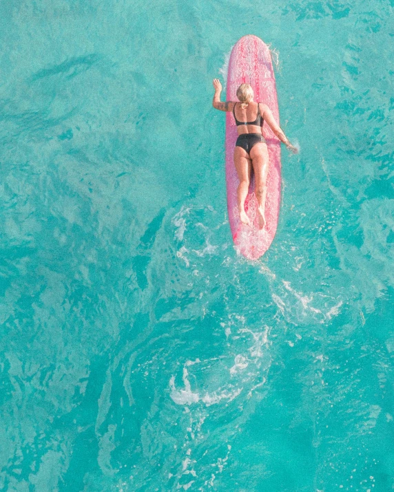 a woman riding on top of a pink surfboard in the ocean, pexels contest winner, brown and cyan color scheme, thumbnail, flatlay, tanned skin