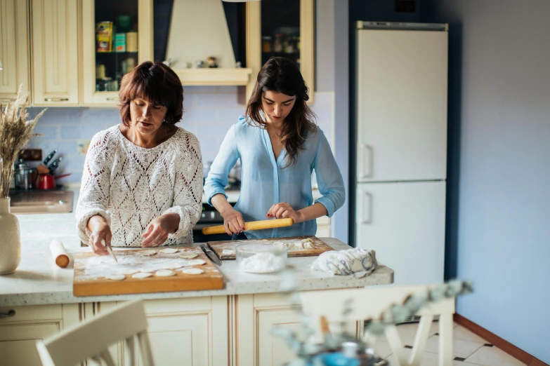 a couple of women standing in a kitchen preparing food, pexels contest winner, renaissance, fan favorite, romanian heritage, baking cookies, profile image