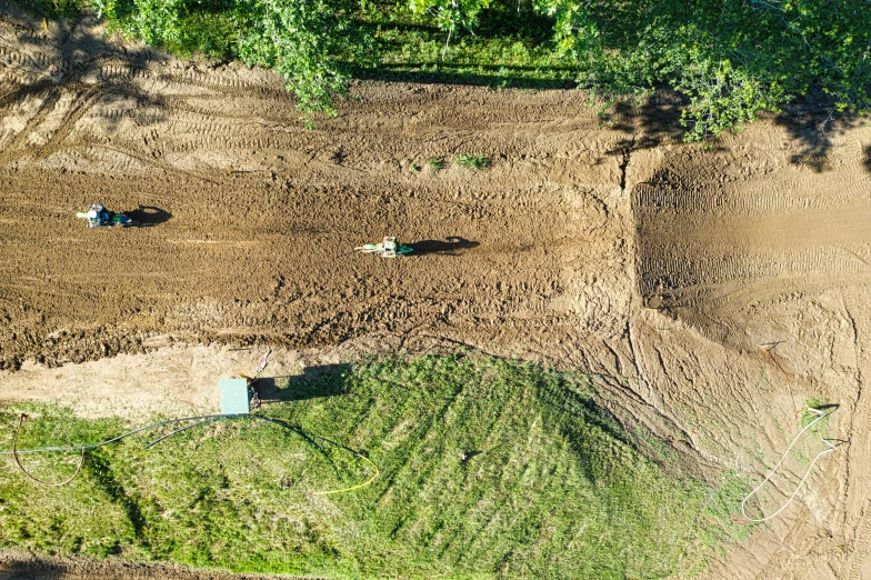 a couple of tractors that are in the dirt, a photo, by Daniel Lieske, land art, avatar image, airborne view, motocross rider on dirt jump, work in progress