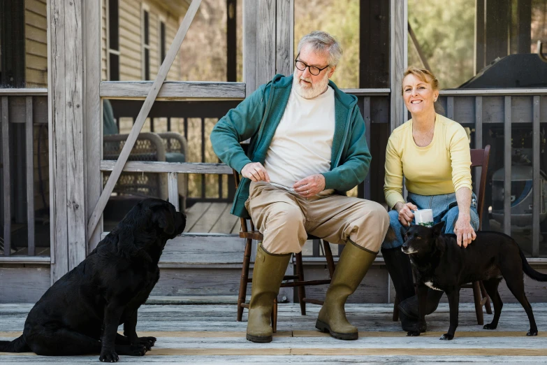 a man and woman sitting on a porch with two dogs, a portrait, by David Garner, unsplash, mitch mcconnell as a turtle, country style, avatar image