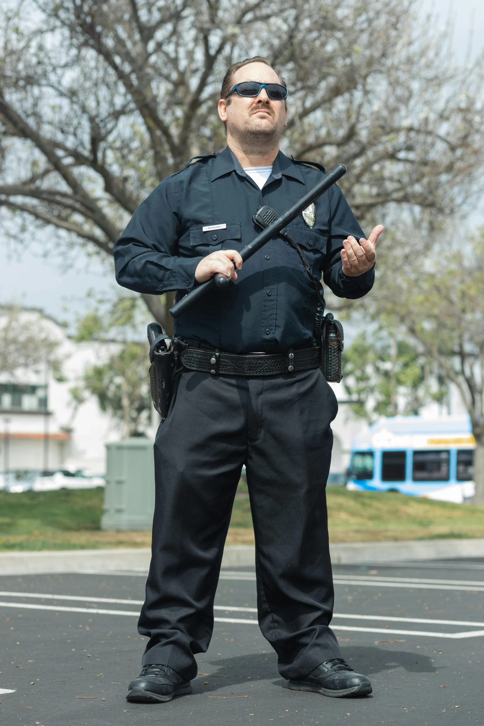 a police officer standing in the middle of the street, a portrait, reddit, holding a big two - handed staff, california;, promo image, security