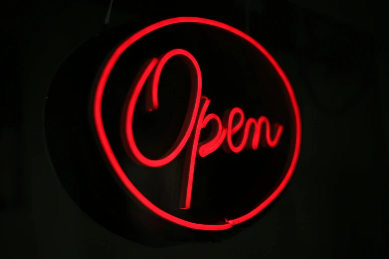 a red open sign hanging from the side of a building, by Josh Bayer, pexels, rococo cyber neon lighting, round about to start, black, indoor picture