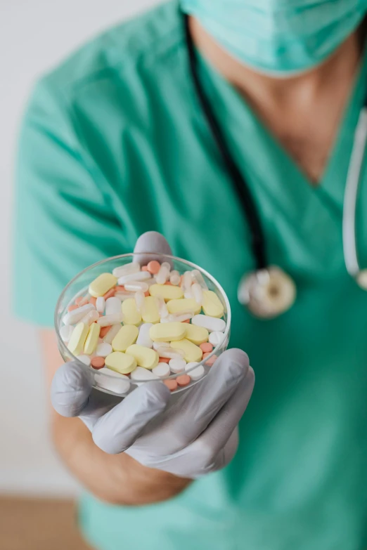 a nurse holding a bowl of pills, pexels, antipodeans, made of nanomaterials, pastel', movie still, photograph credit: ap