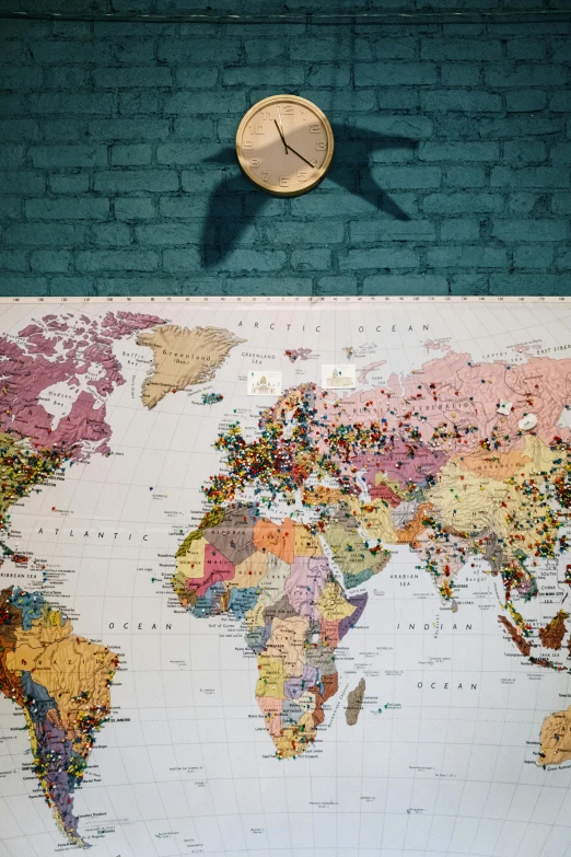 a wall with a map of the world on it, by Art & Language, trending on unsplash, fan favorite, color corrected, clock, conde nast traveler photo