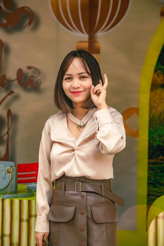 a woman holding a cell phone up to her ear, a picture, inspired by Ruth Jên, instagram, wearing honey - themed miniskirt, pixar portrait 8 k photo, wearing a blouse, square