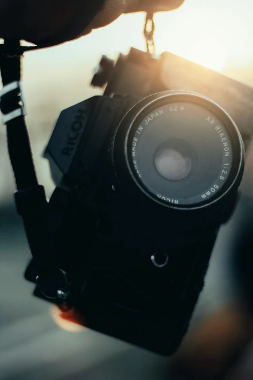 a close up of a person holding a camera, pexels contest winner, photorealism, grainy quality, medium format. soft light, today\'s featured photograph 4k, towering over the camera