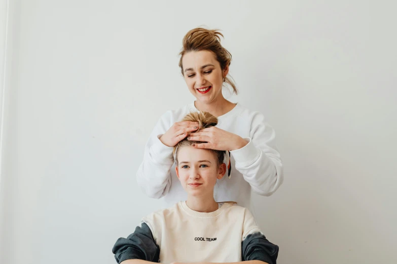 a woman getting her hair cut by a hair stylist, by Emma Andijewska, trending on pexels, hurufiyya, caring fatherly wide forehead, regal pose, on a white table, straya