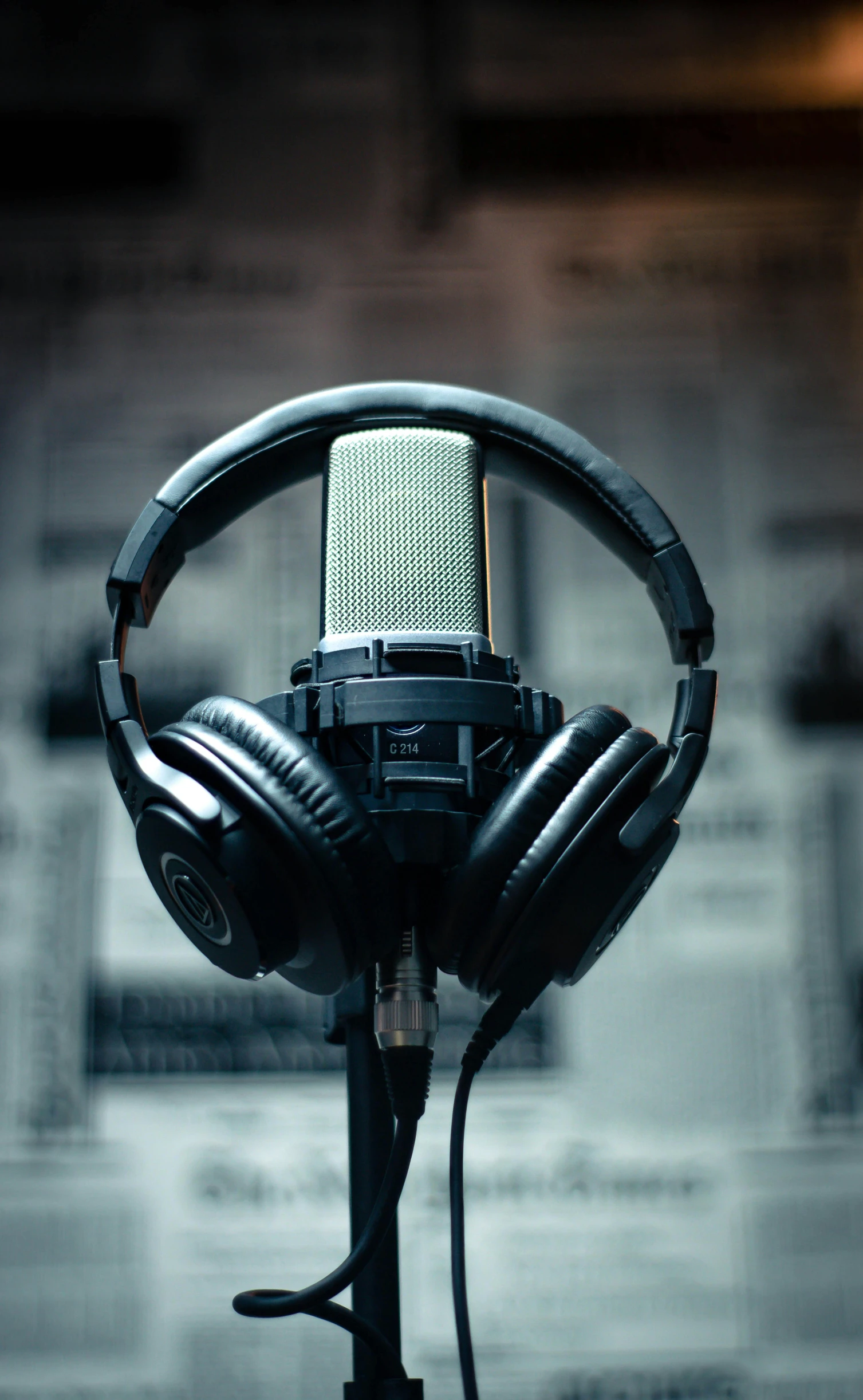 a microphone with headphones on top of it, by Robbie Trevino, trending on pexels, private press, studio backlight, thumbnail, high quality photo, grainy footage